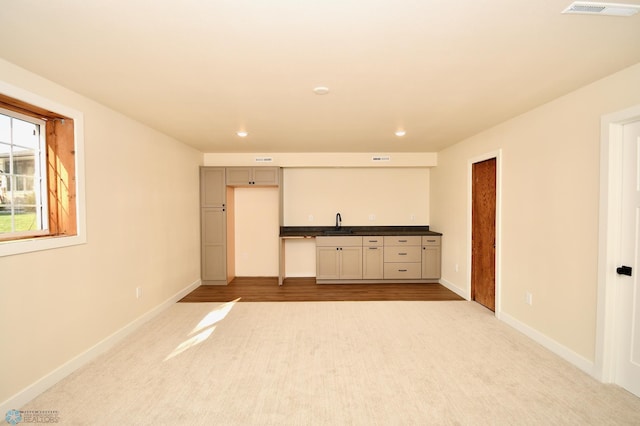 interior space featuring sink and light carpet