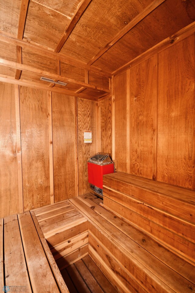 view of sauna / steam room with wood ceiling and wood walls