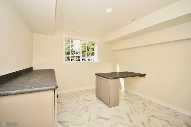 interior space with a kitchen bar, a kitchen island, and kitchen peninsula