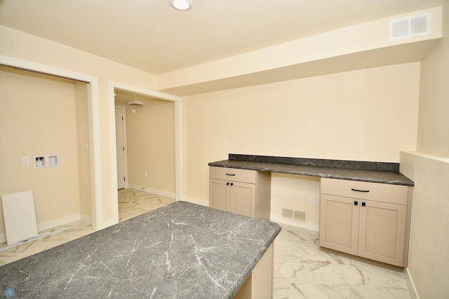 kitchen with built in desk and cream cabinets