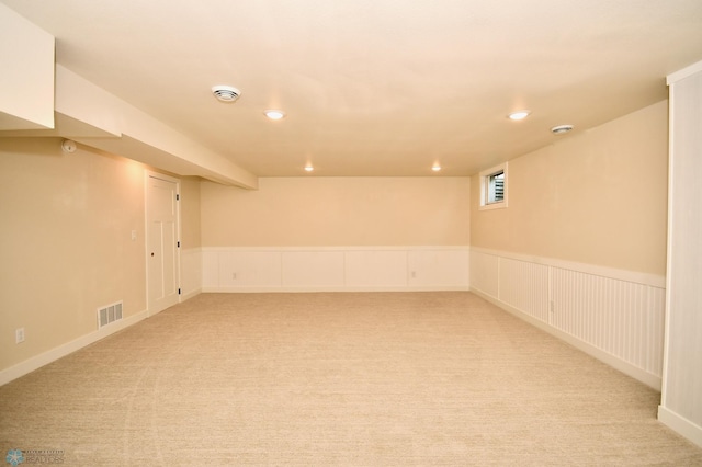 basement featuring light colored carpet