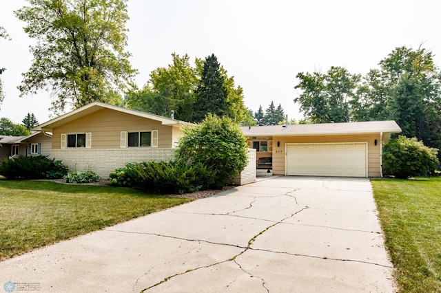 ranch-style house featuring a garage and a front yard