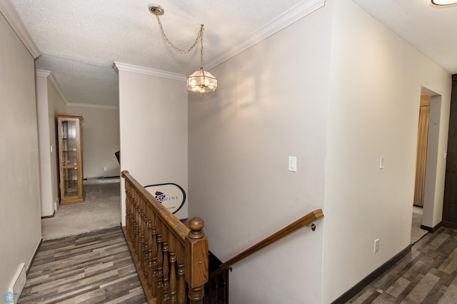 stairway featuring a textured ceiling, crown molding, carpet, and a notable chandelier