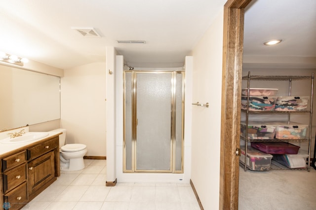 bathroom with a shower with door, vanity, and toilet