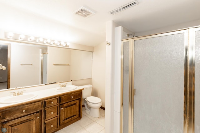 bathroom with tile patterned floors, vanity, toilet, and a shower with shower door