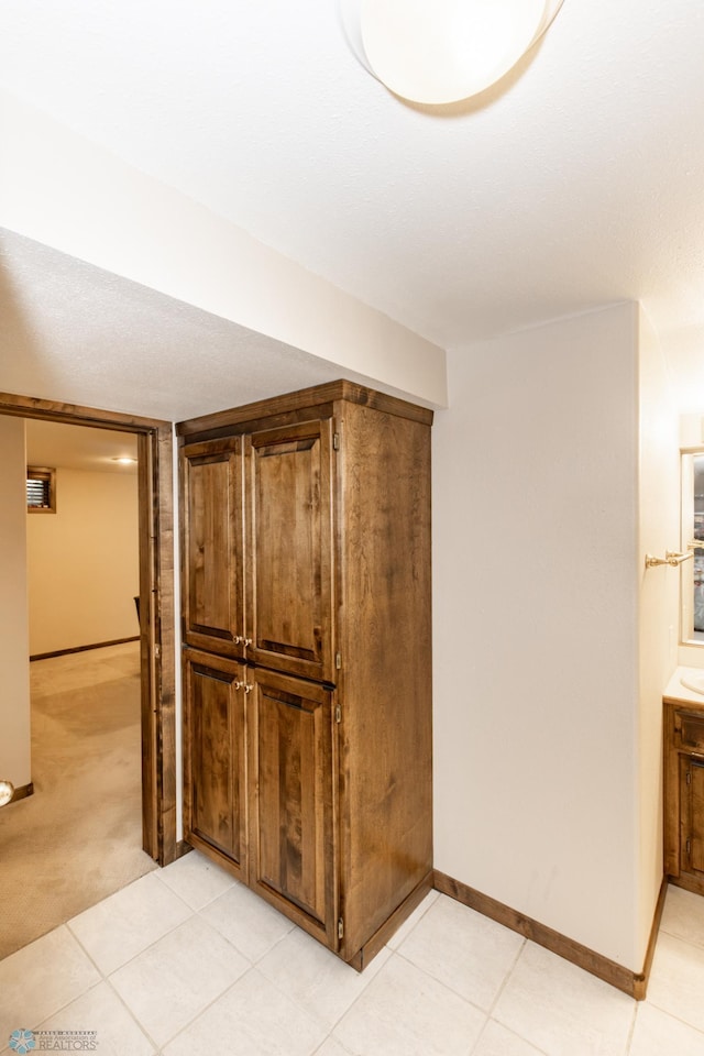 interior space featuring a textured ceiling and carpet floors