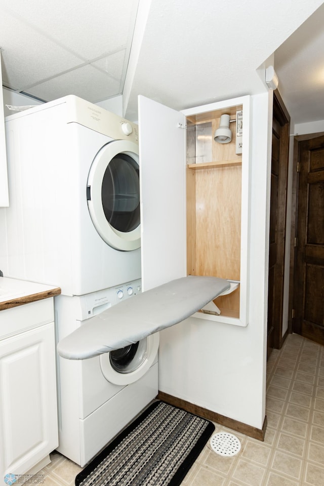 laundry room with stacked washer / dryer