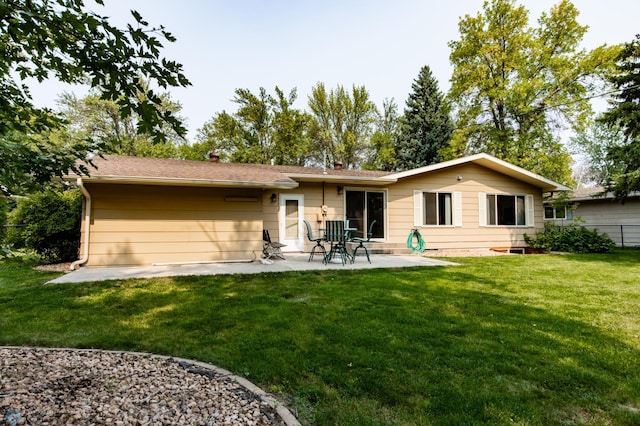 back of property with a lawn and a patio