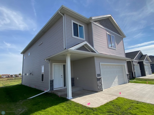 view of front facade featuring a garage and a front lawn