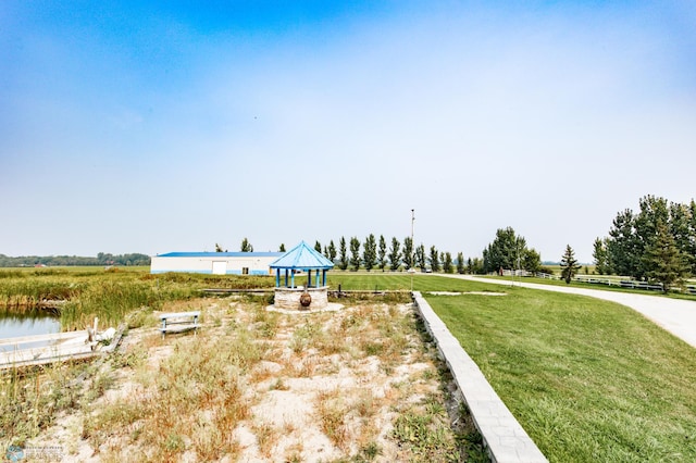 view of yard featuring a gazebo and a water view