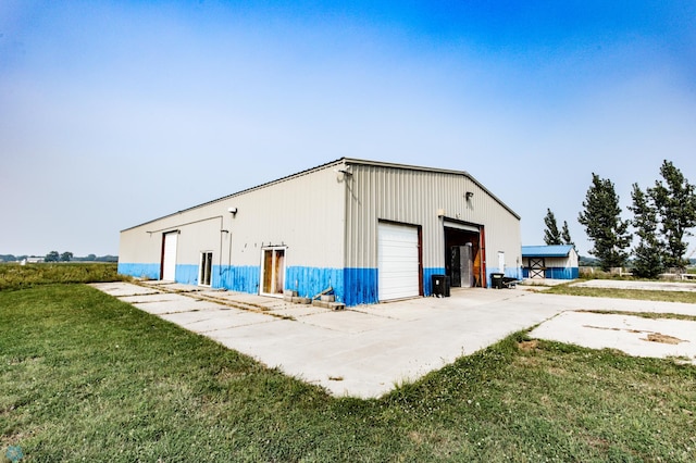 view of outbuilding with a yard and a garage