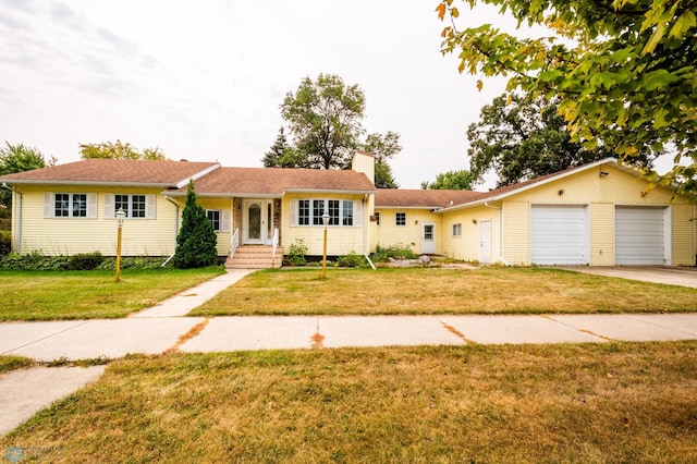 ranch-style house featuring a garage and a front yard