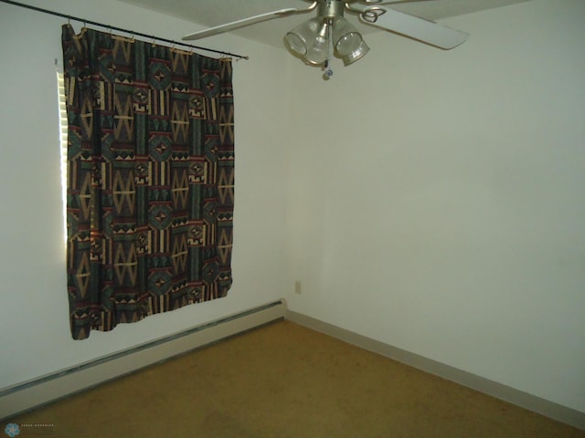 carpeted spare room with ceiling fan and a baseboard radiator