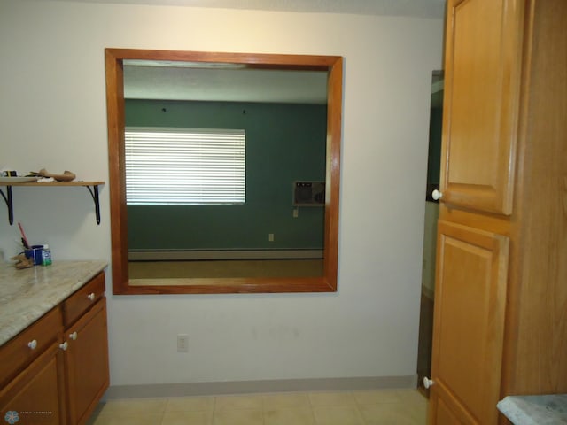 bathroom with baseboard heating and vanity