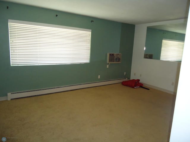 carpeted empty room with a baseboard radiator