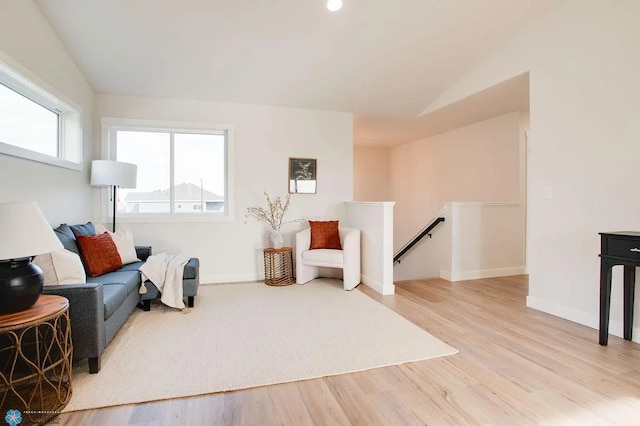 living area featuring hardwood / wood-style flooring and vaulted ceiling