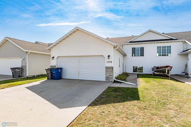 view of front of property with a front yard and a garage