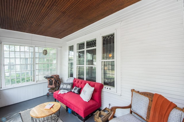 sunroom featuring wooden ceiling and a healthy amount of sunlight