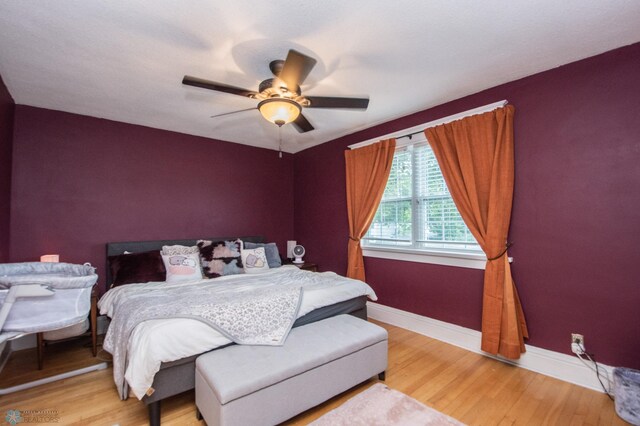 bedroom with ceiling fan and light hardwood / wood-style flooring