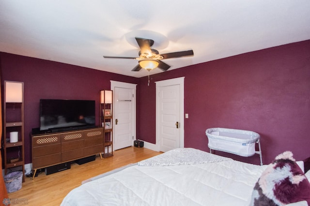 bedroom with ceiling fan and hardwood / wood-style floors