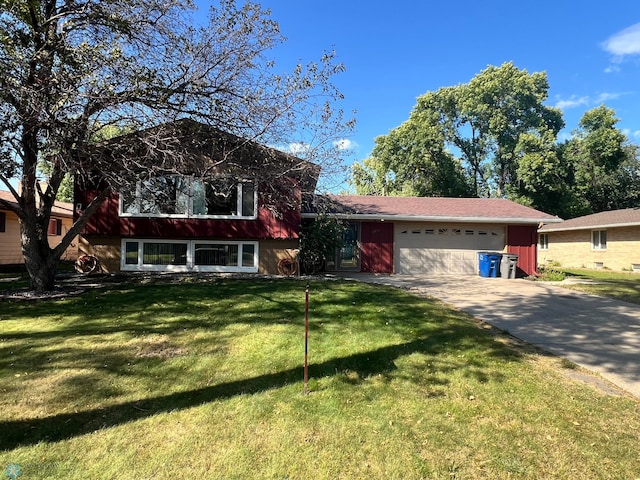 tri-level home featuring a front lawn and a garage