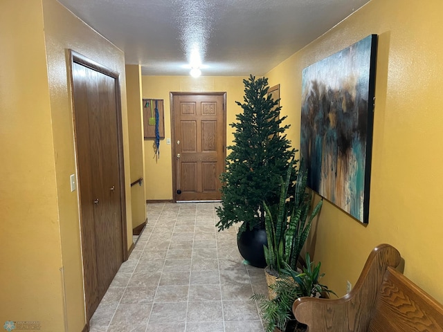 hallway with a textured ceiling