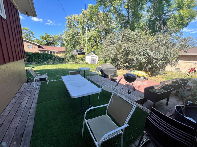 exterior space featuring a patio and a storage shed