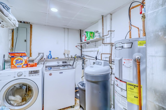 clothes washing area with washer and clothes dryer, water heater, and electric panel