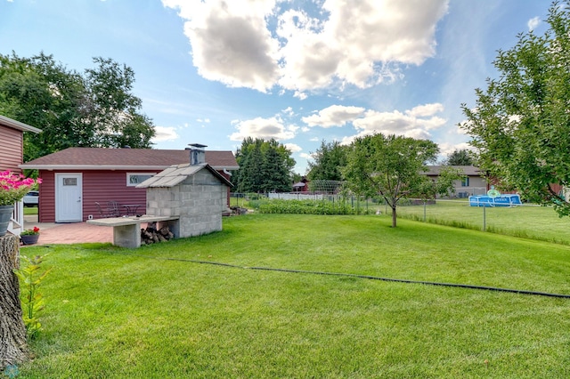 view of yard featuring a shed and a patio