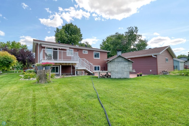 rear view of property featuring a wooden deck and a lawn