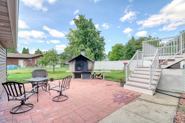 view of patio with a fireplace