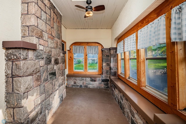 unfurnished sunroom featuring ceiling fan and wooden ceiling