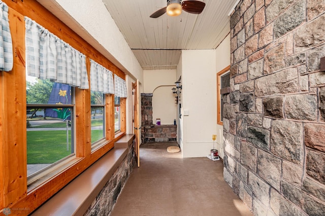 sunroom / solarium featuring ceiling fan