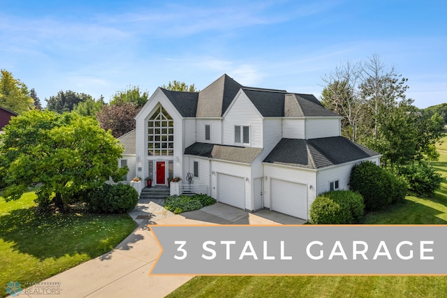 view of front of house featuring a front yard and a garage