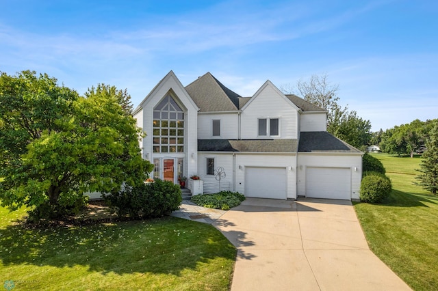 view of front of property featuring a front yard and a garage