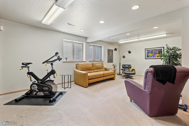 carpeted living room featuring a textured ceiling