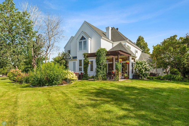 view of front of property with a pergola and a front yard