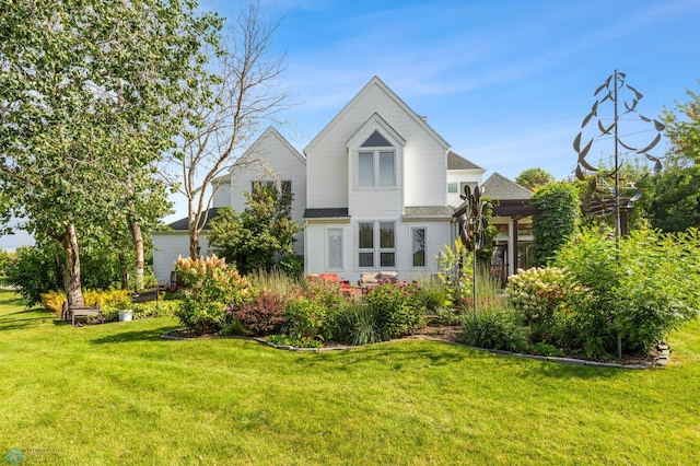 rear view of house with a yard