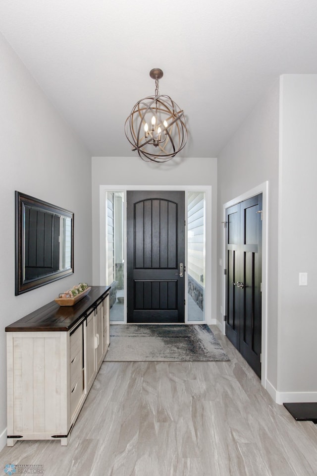 entrance foyer with a notable chandelier and light hardwood / wood-style floors