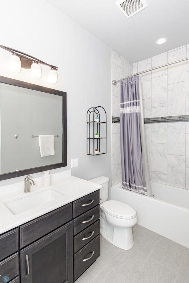 full bathroom with tile patterned floors, vanity, shower / bath combo with shower curtain, and toilet