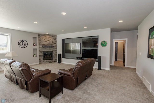 living room featuring light carpet and a stone fireplace