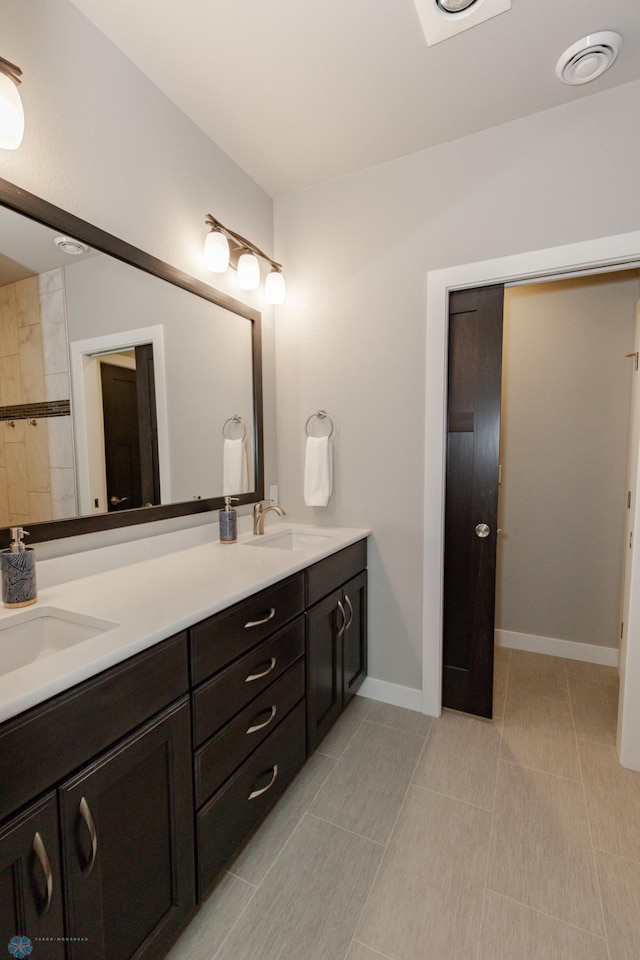 bathroom with vanity and tile patterned flooring