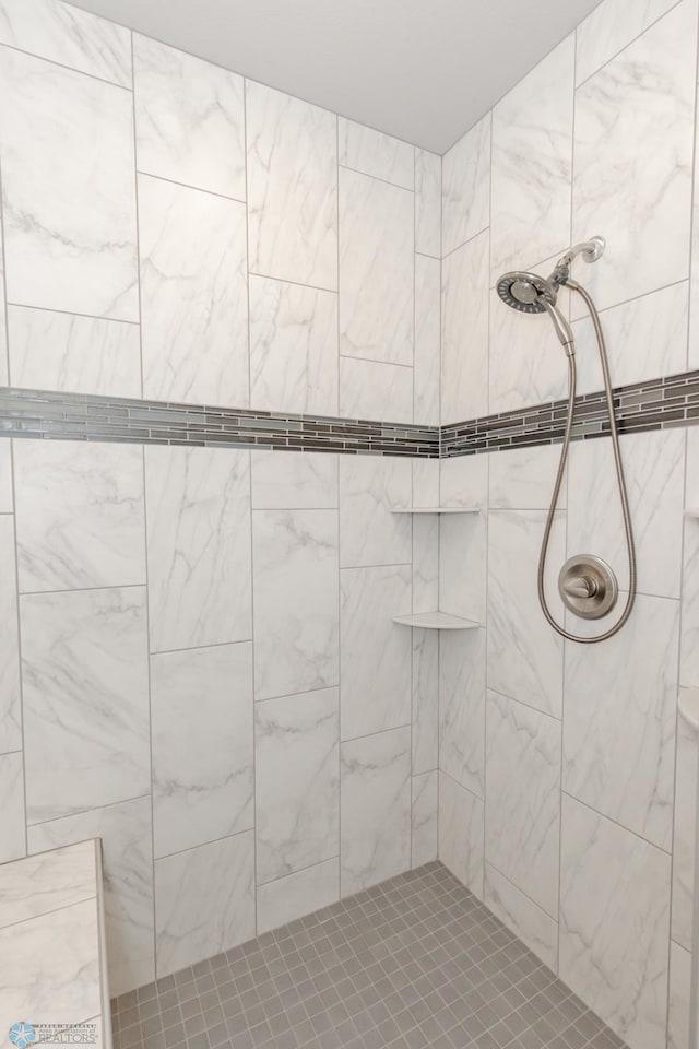 bathroom with tiled shower