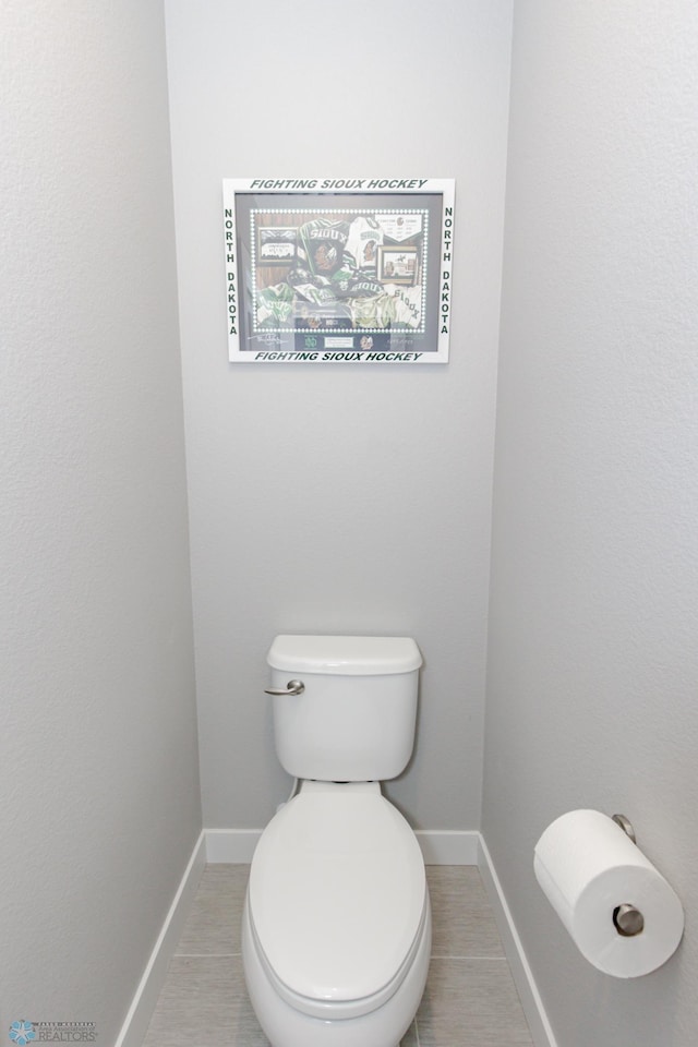 bathroom featuring toilet and tile patterned floors