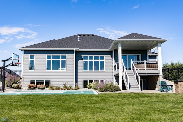 rear view of property with a lawn