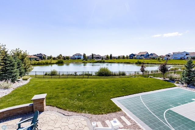 view of yard featuring basketball court and a water view