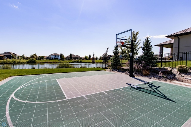 view of sport court featuring a water view