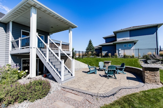 view of patio / terrace with an outdoor fire pit and a deck