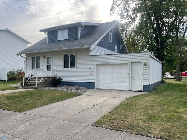 view of front of home featuring a garage and a front lawn