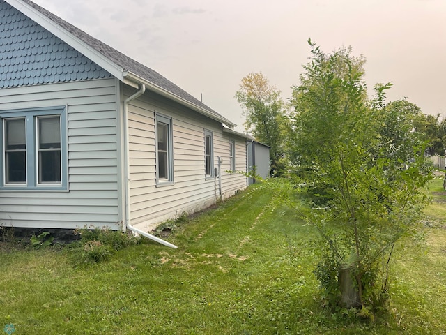 view of home's exterior with a lawn